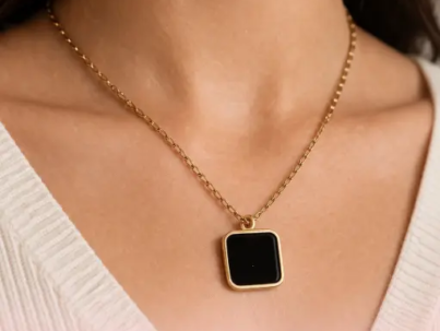 Elysian Black pendant stainless steel anti tarnish gold tone square black pendant on pink background